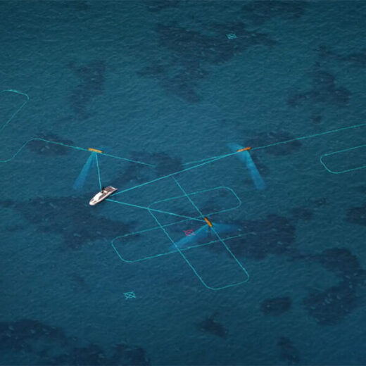 Aerial view of a small white sailboat with blue wings on turquoise ocean, surrounded by light blue outline shapes in the water.