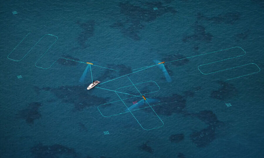 Aerial view of a small white sailboat with blue wings on turquoise ocean, surrounded by light blue outline shapes in the water.